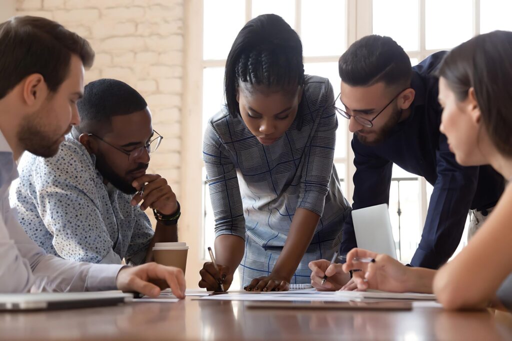 Focused African American Millennial Female Team Leader Writing Notes