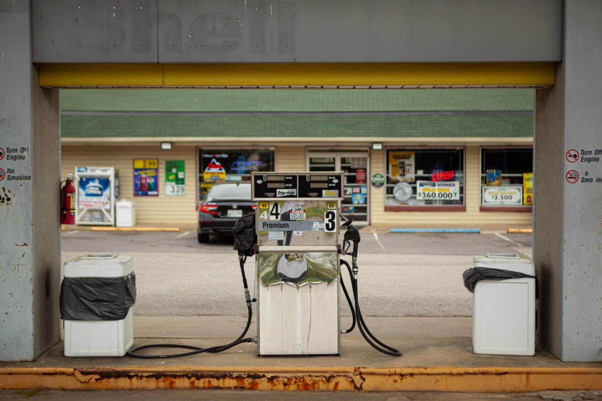 Gas pump in front of a small gas station