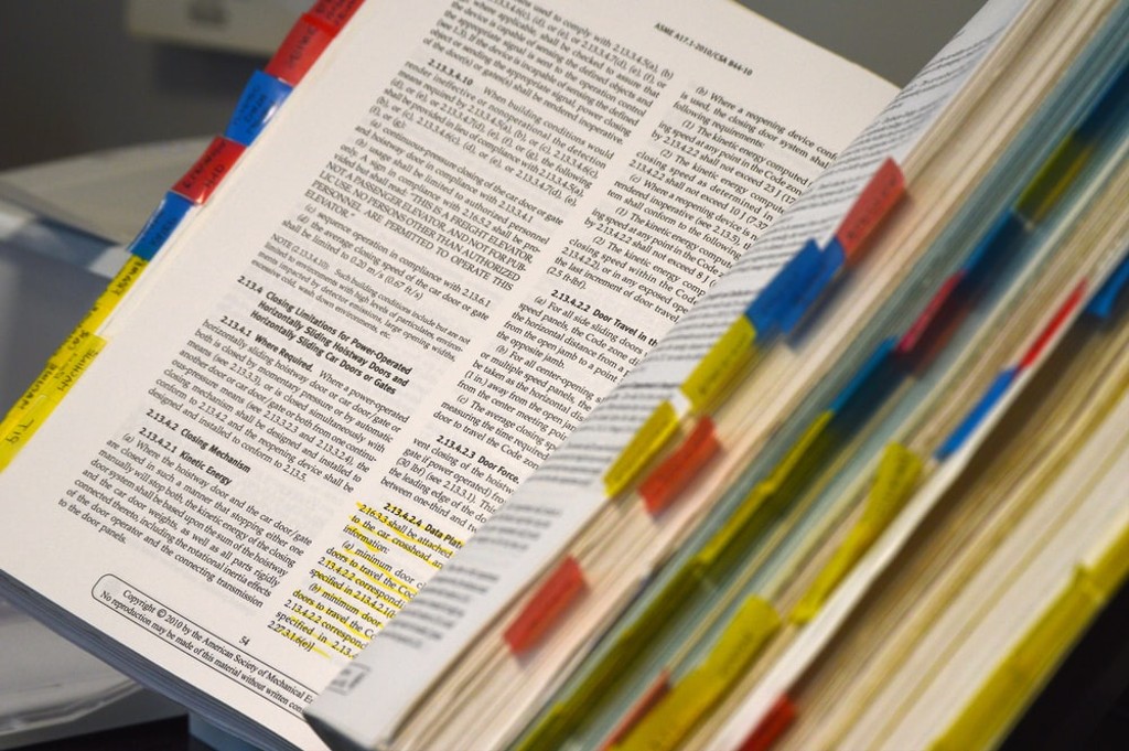 Book open with man colored tabs between the pages