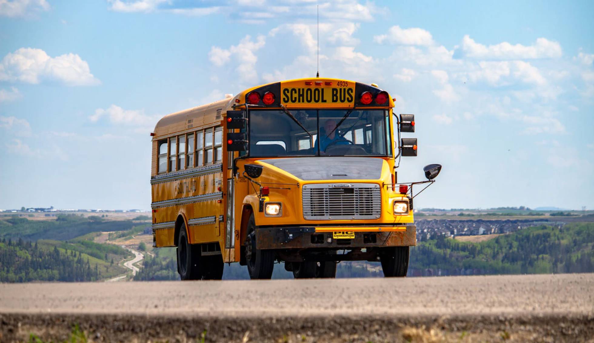 School bus driving on a country road
