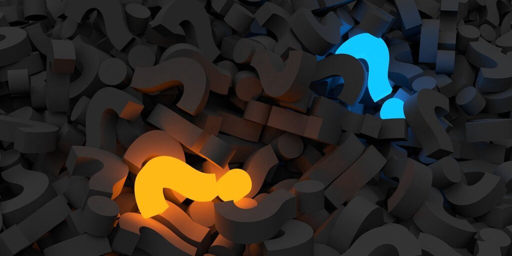 A pile of graphic question marks that are all gray besides one colored orange and one colored blue