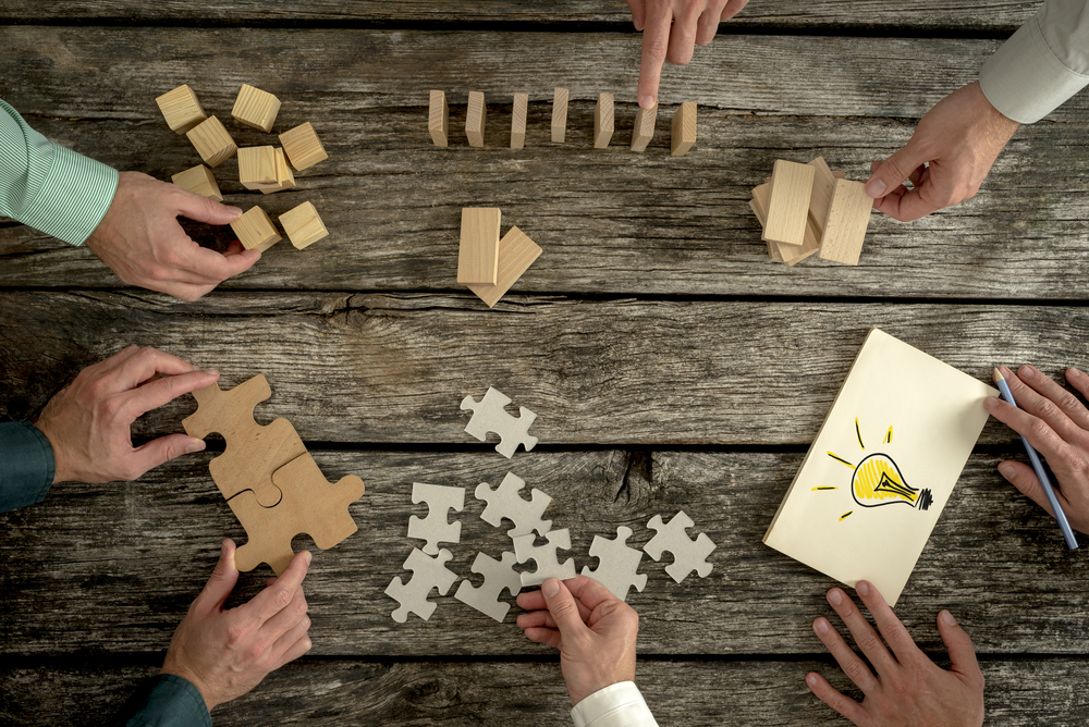 puzzle and wood pieces on a wood picnic table