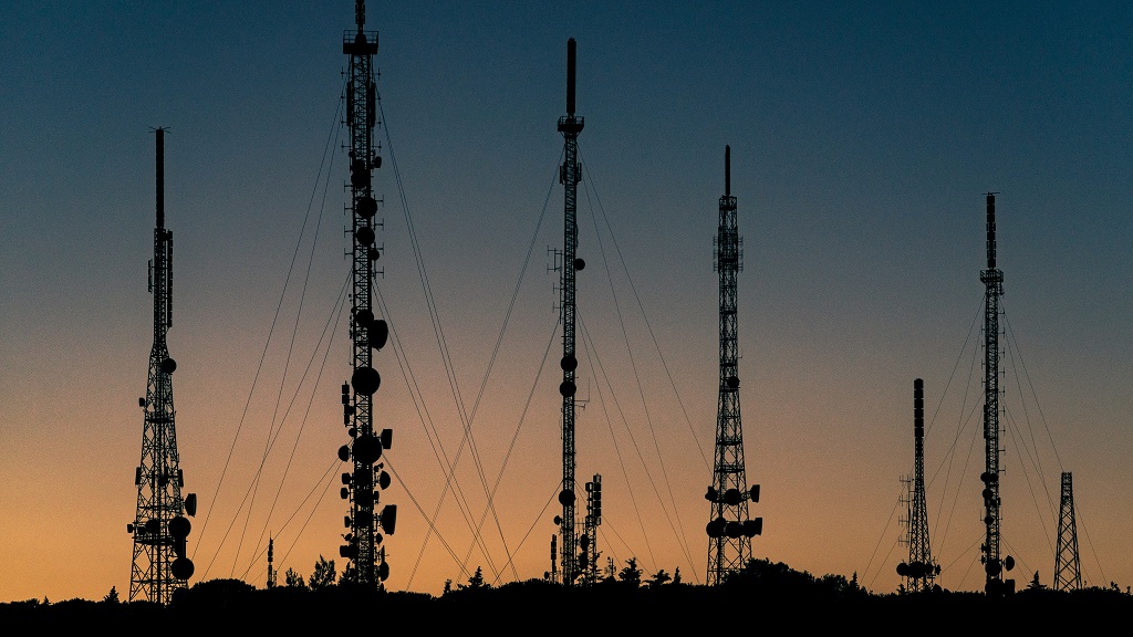 A group of telecommunication towers at evening