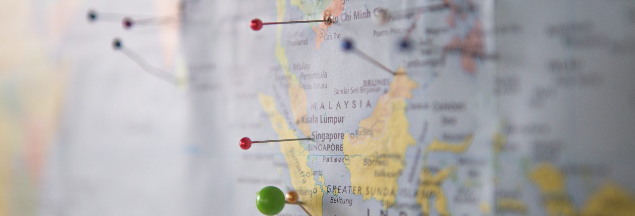 Close up of multiple colored pins in a map of Malaysia