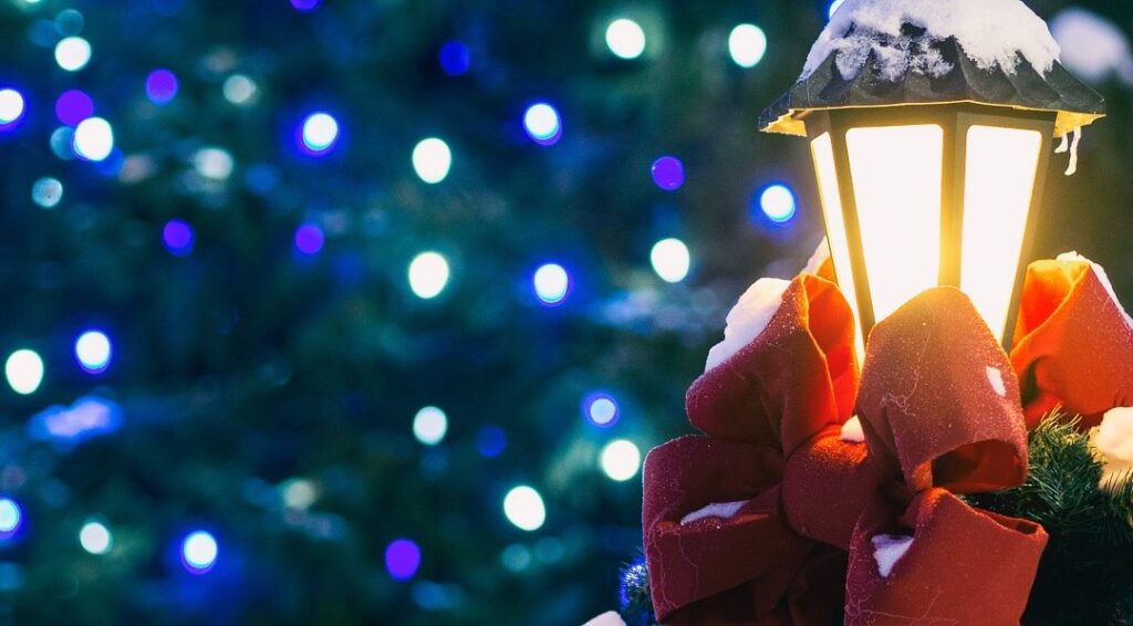 Christmas lamppost with a red bow and snow