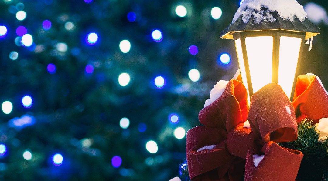Christmas lamppost with a red bow and snow