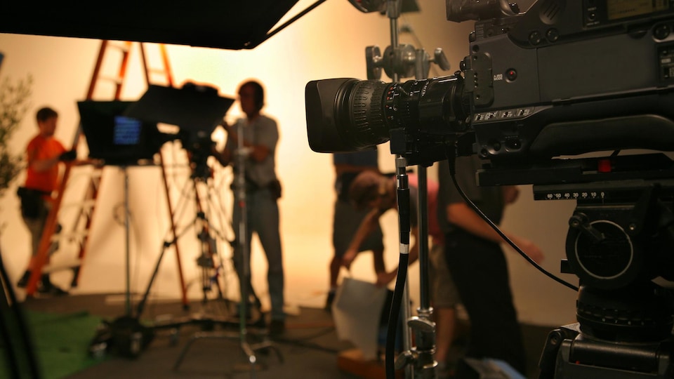 film crew setting up a scene in a studio