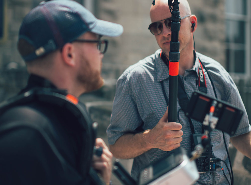 Audio tech and camera operator talking