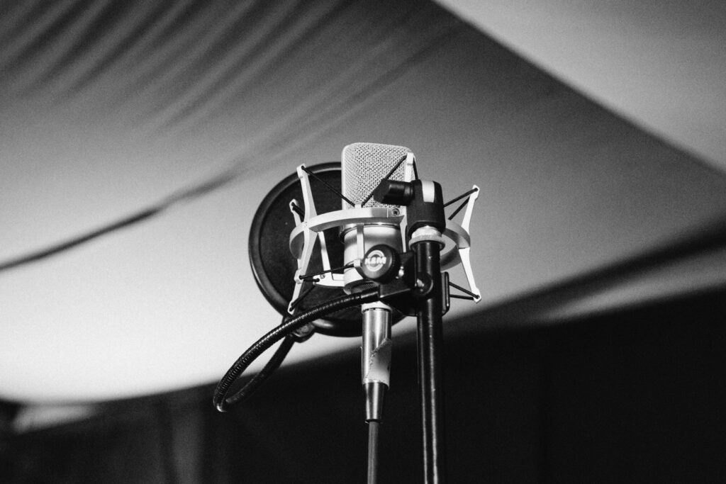 close up black and white image of a microphone set up for recording