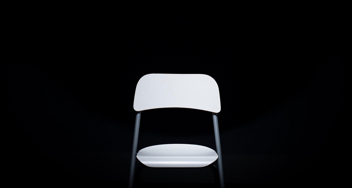 White chair in a black space