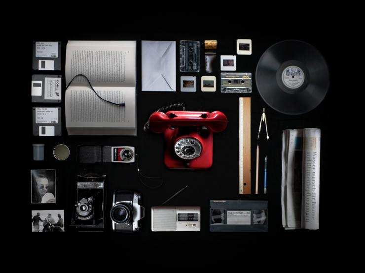 A series of old audio, film, and technology on a solid black background