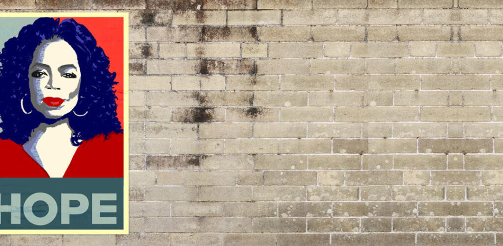Grey brick wall with a graphic poster on the left side of Oprah Winfrey with the text "HOPE" below her in a red and blue presidential style