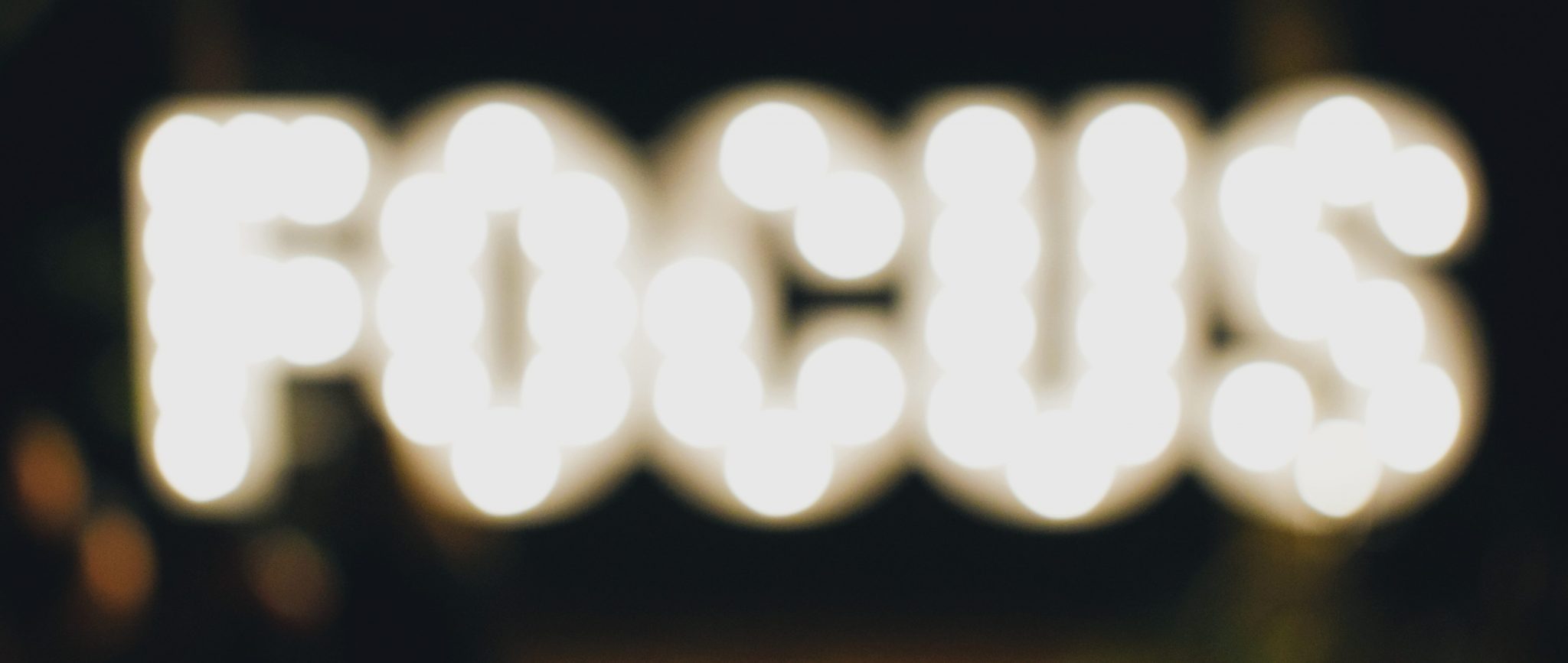 The text "focus" made by a series of yellow illuminated circles