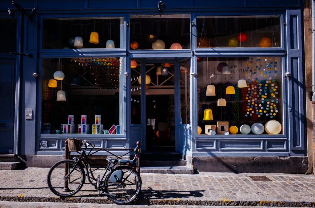 Storefront with a stone road and bicycle out front