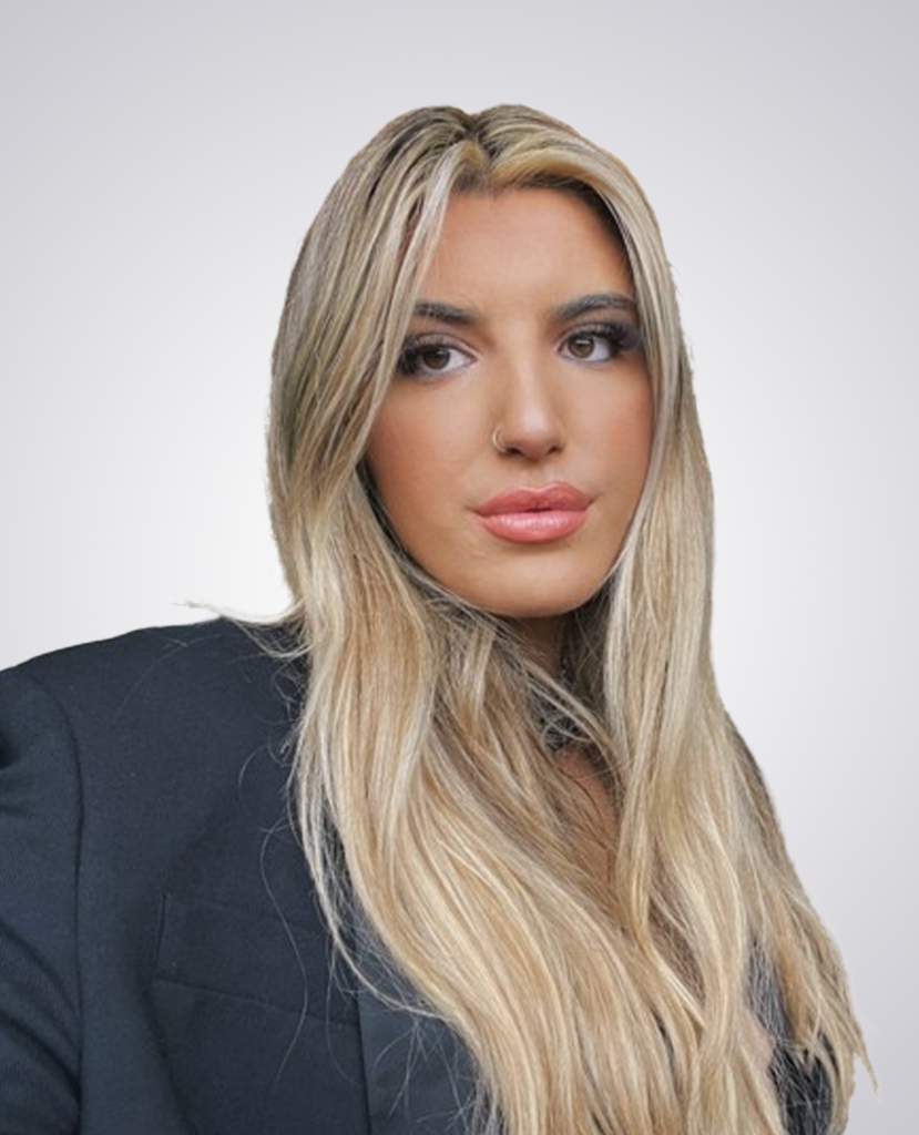 Professional headshot of blonde women with black blazer on a white background