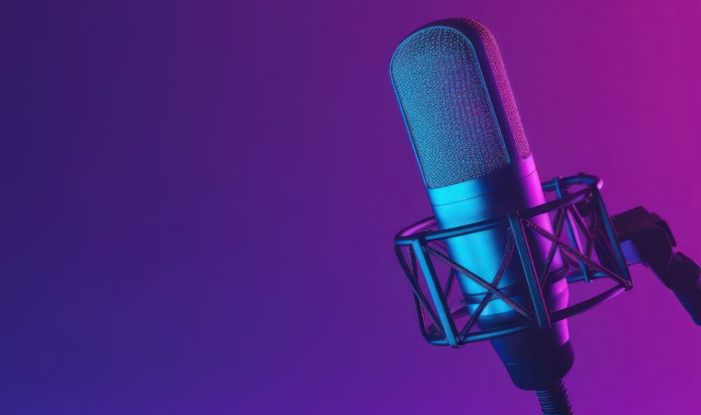 Close up of microphone on purple and pink gradient background