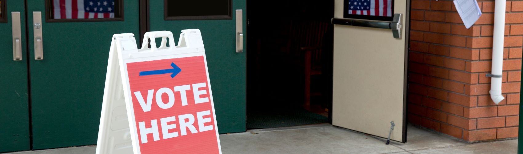 Vote here sign in front of a open door
