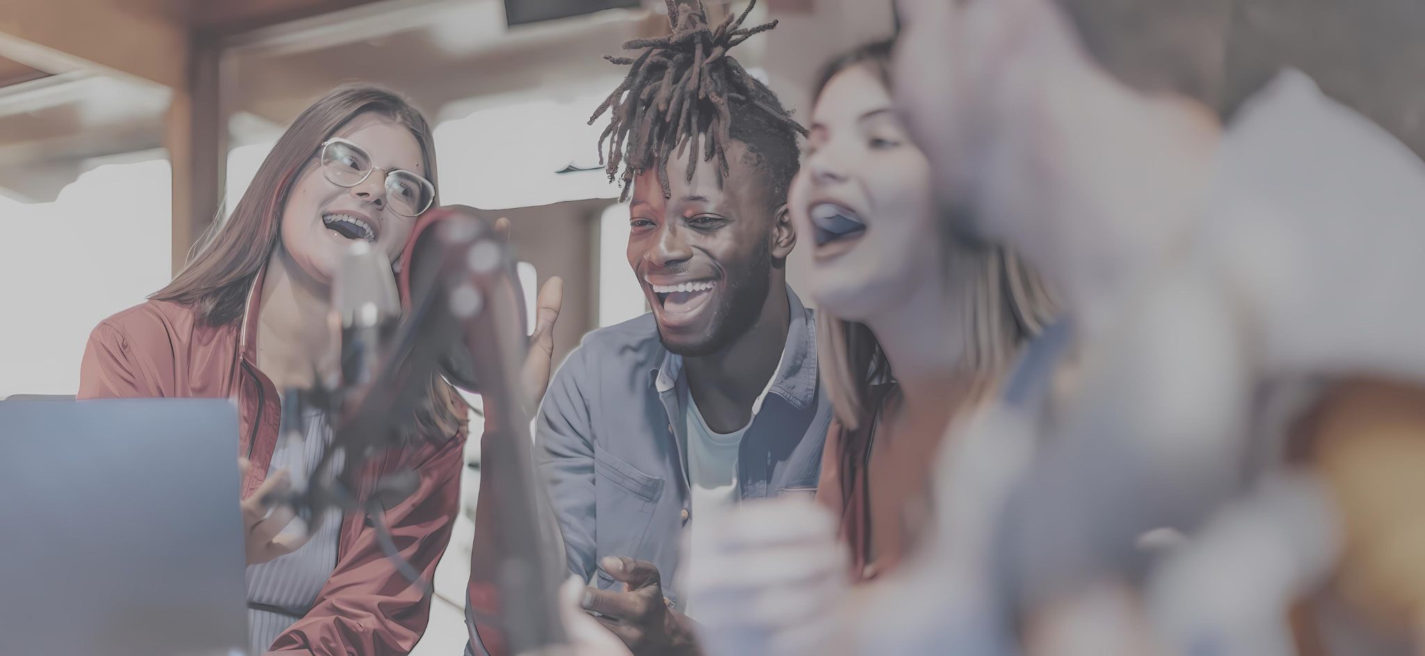 People laughing and talking in podcast mic