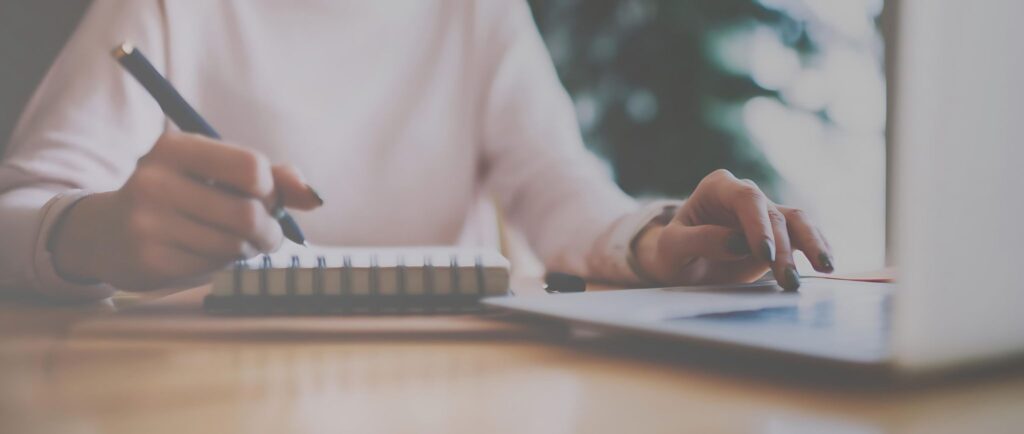 Women writing content on notepad