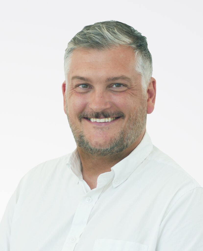 Professional Headshot of a smiling man in a white shirt