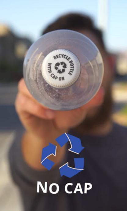 close up of a man holding a plastic bottle pointing at the camera with a recycling graphic and the text "no cap" below