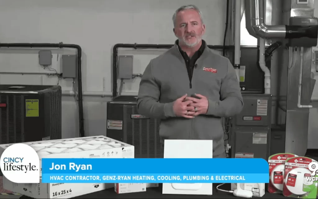 man talking in front of HVAC equipment