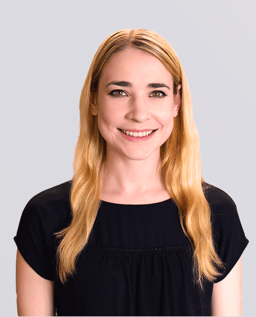 Professional headshot of a smiling woman in a black shirt