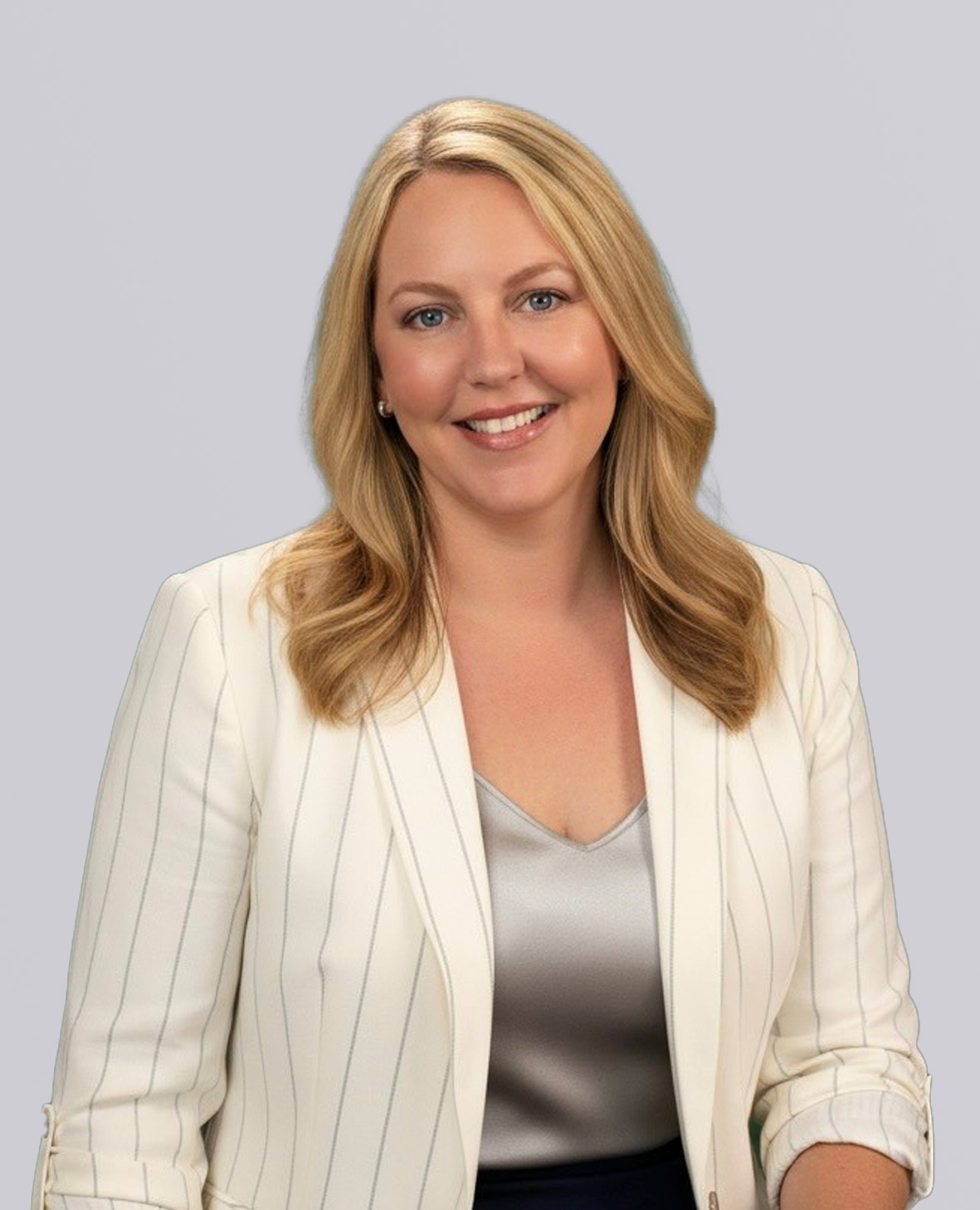 Professional headshot of a smiling blonde woman in a white jacket and gray top.