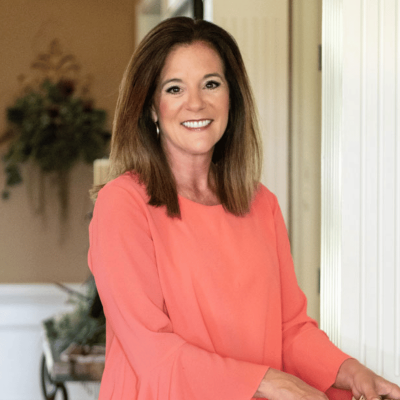 Headshot of a smiling woman in a pink sweater